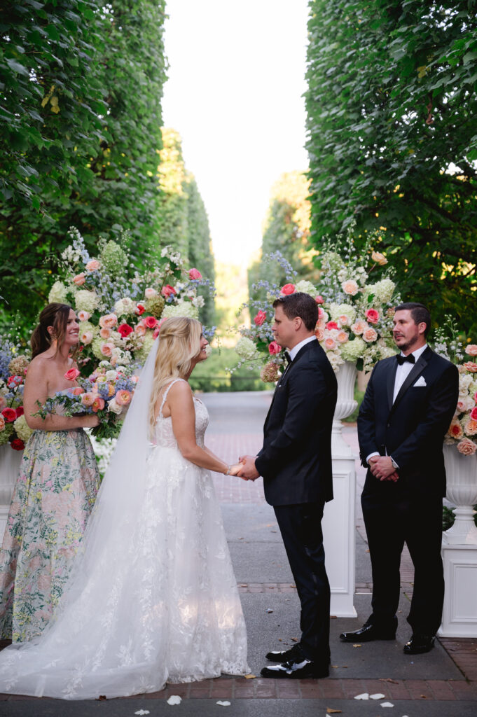 Bride and groom getting married at the Chicago Botanic Garden surrounded by flowers and greenery